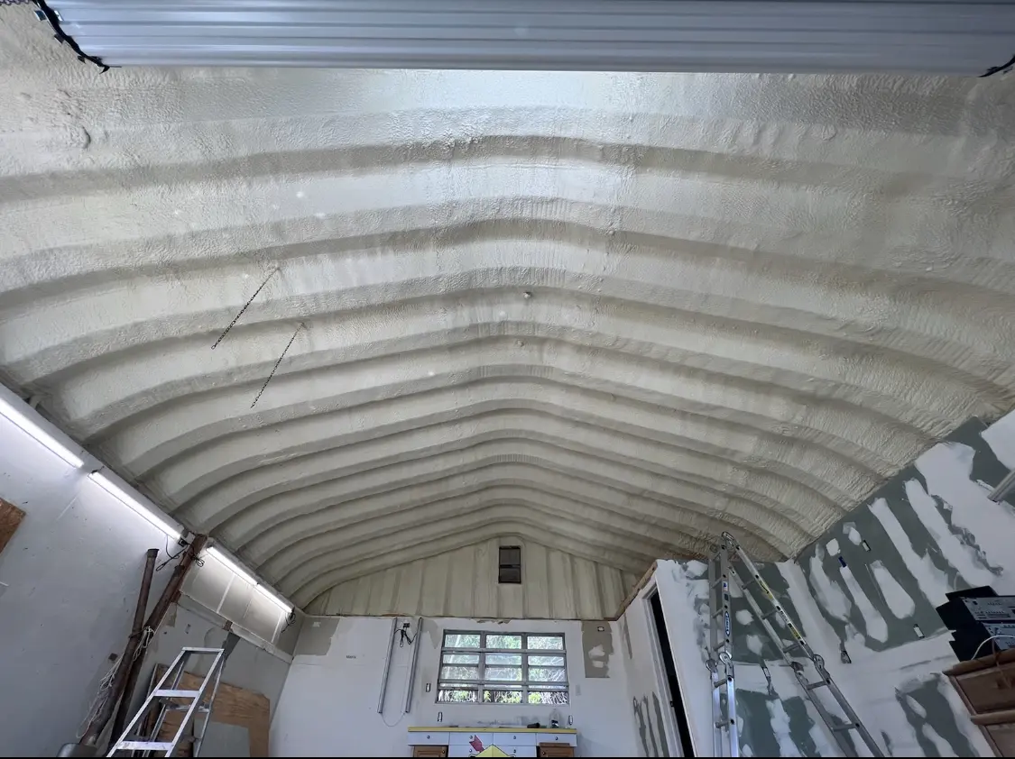 Spray polyurethane foam applied to the underside of a metal roof deck in Walworth